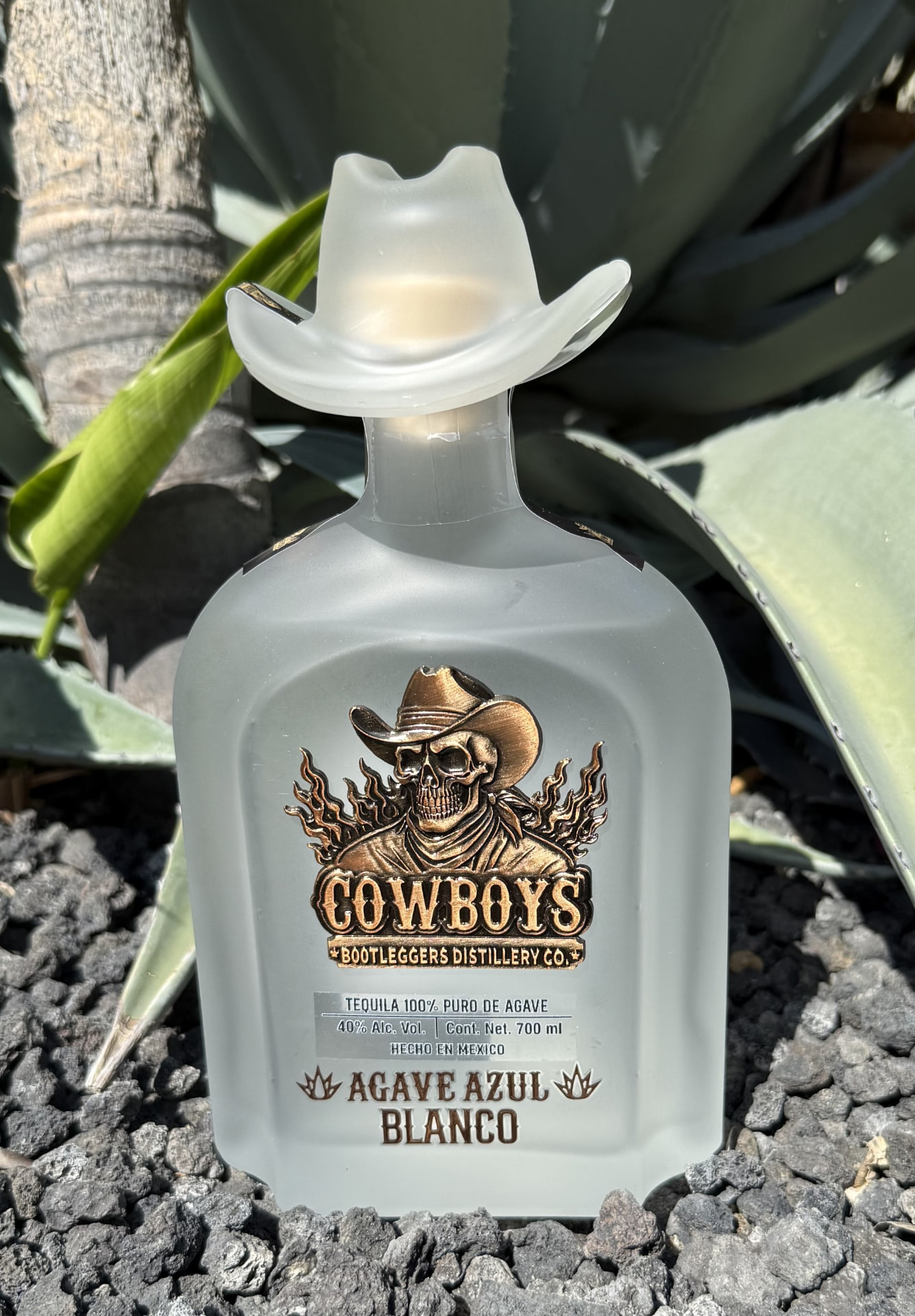 Frosted-white Cowboys Bootleggers Distillery Co. bottle with cowboy-hat stopper — Agave Azul Blanco